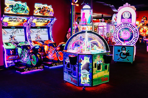 Colorful arcade with racing games and prize machines at King’s Entertainment