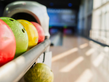 colorful bowling balls with lane in background 