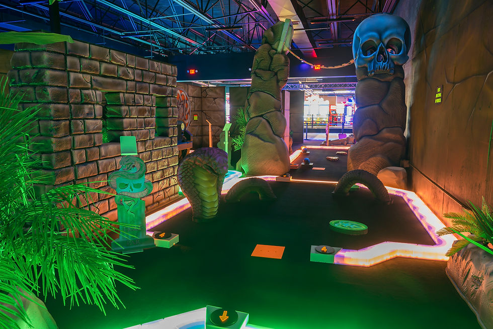 Mini golf course with glowing jungle walls and stone paths at King’s Entertainment