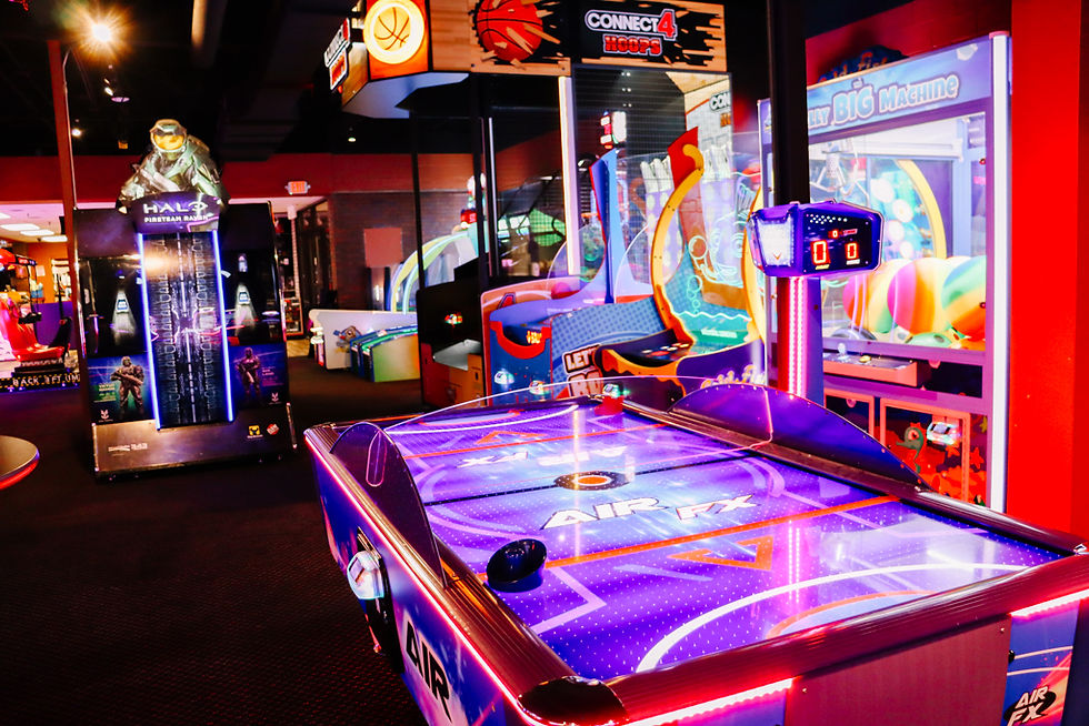 Air hockey table and arcade games under neon lights at King’s Entertainment in Norfolk, NE