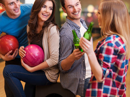 Coworkers enjoying bowling and team building activities at King's Entertainment in Norfolk, Nebraska