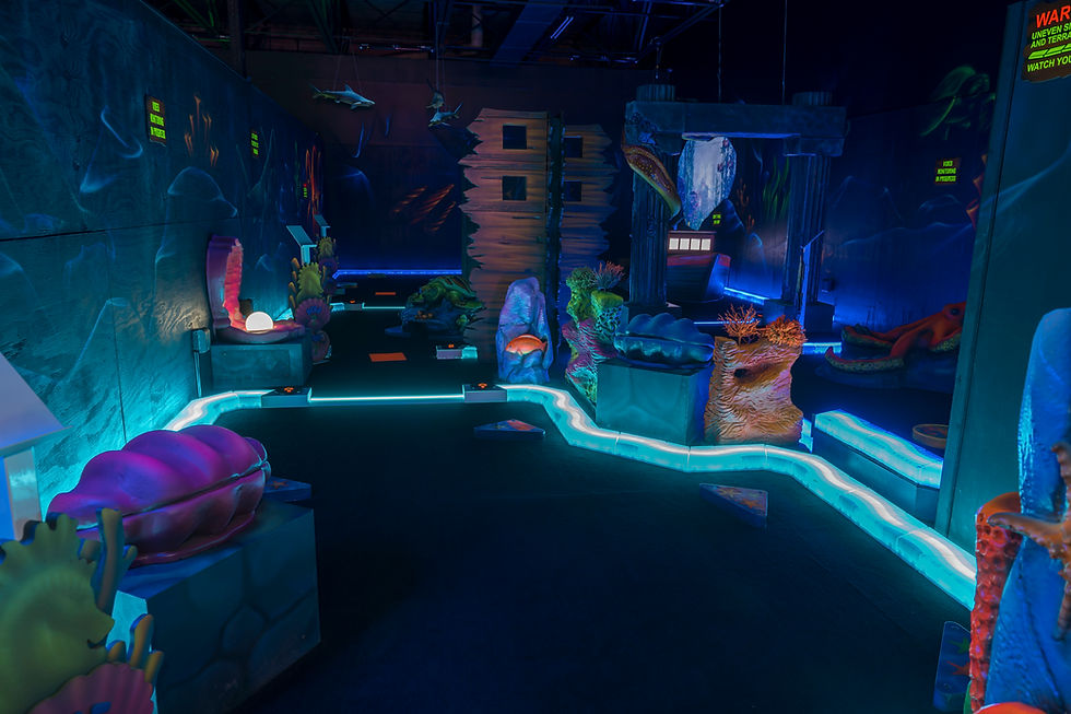 Glow-in-the-dark mini golf hole with ancient ruins and eerie atmosphere