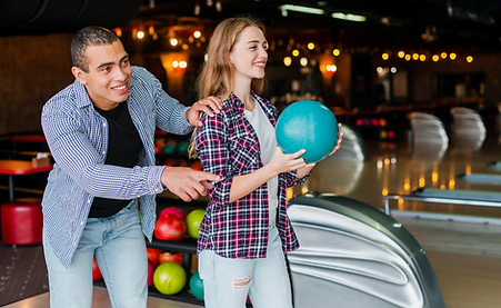 Couple bowling and smiling at King’s Entertainment, Norfolk’s only 10-pin bowling center