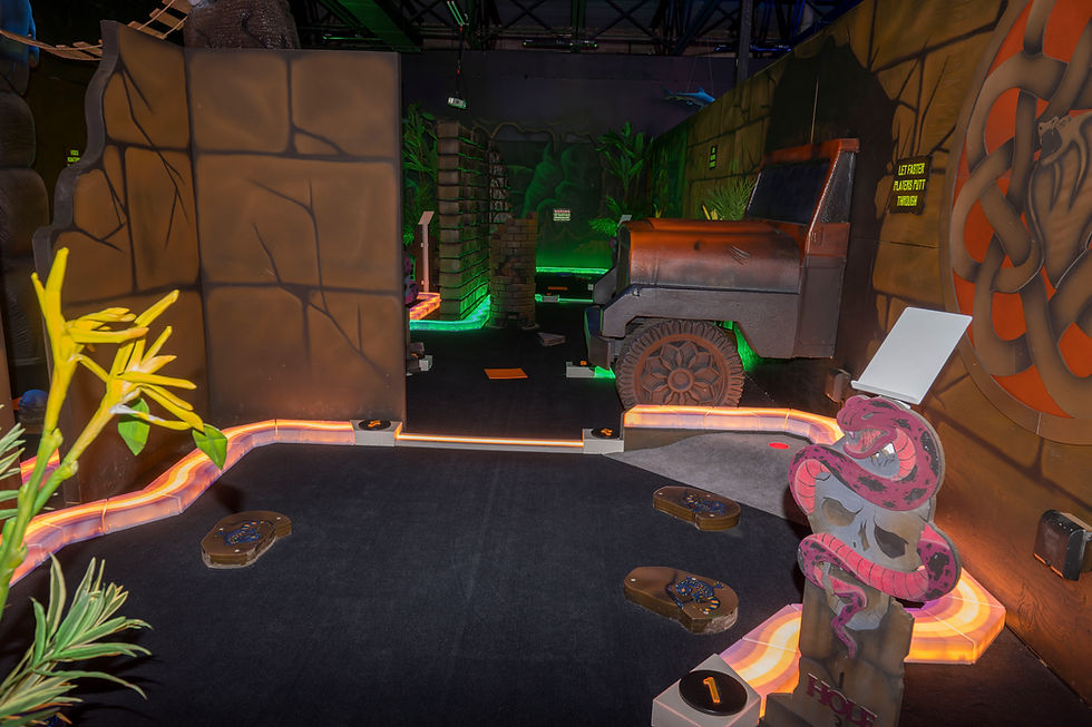 Dark ruins-themed mini golf with glowing skulls and illuminated obstacles
